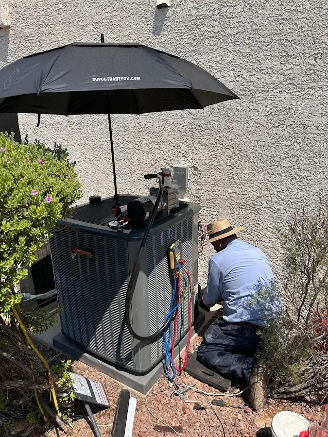 HVAC technician performing outdoor AC maintenance in Indiana
